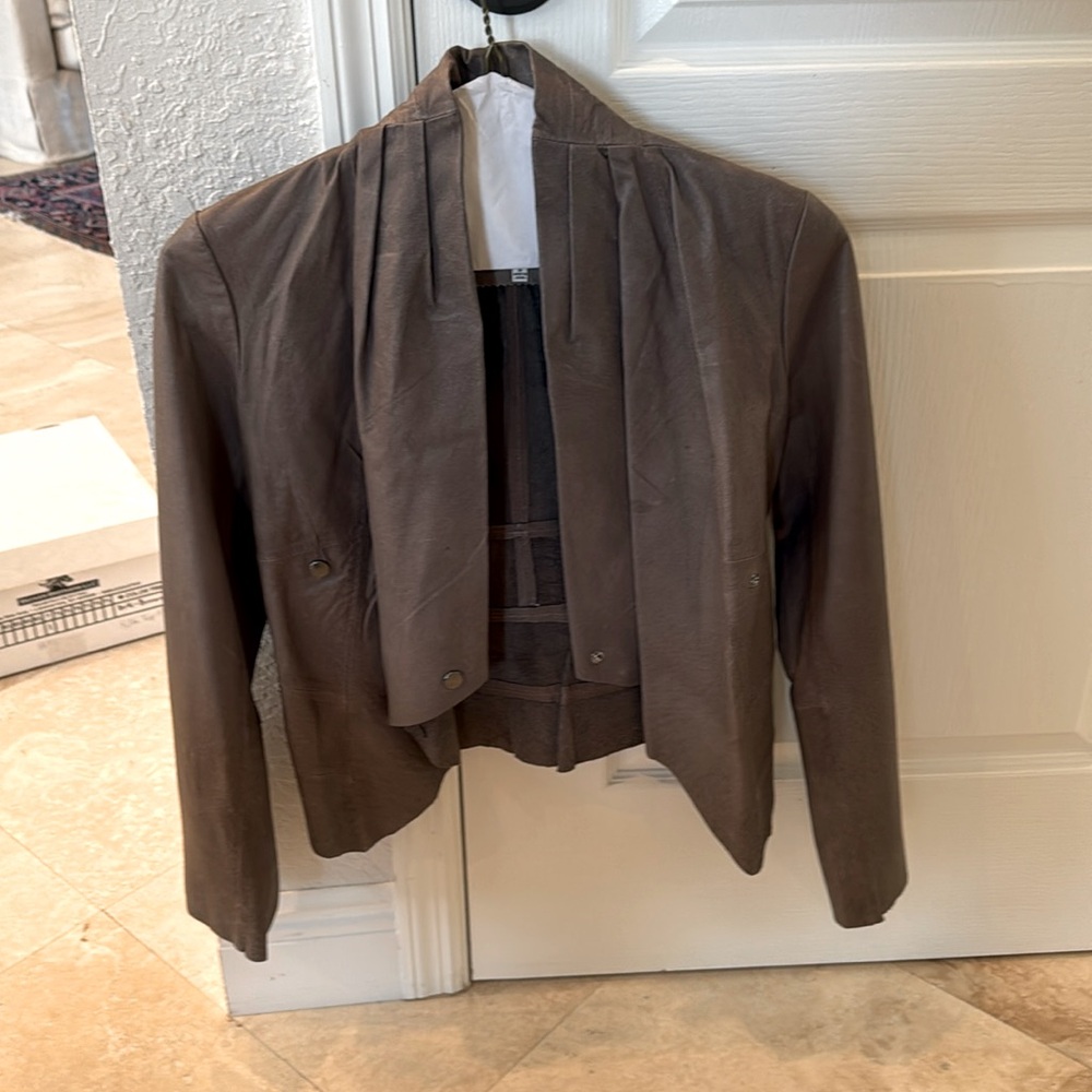 This is a brown women’s jacket. It is a size small.